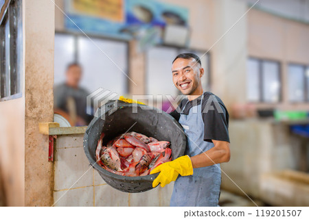 A Happy Fishmonger Proudly Holding Fresh Catch at Local Market for Sale A Happy Fishmonger Proudly Holding Fresh Catch at Local Market for Sale 119201507