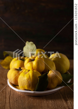 Ripe yellow quince fruits on a plate 119201652