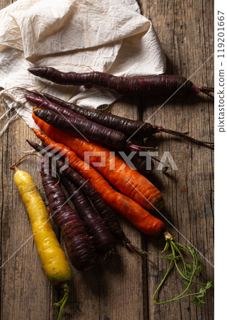 A bunch of colorful organic carrots on a wooden table A bunch of colorful organic carrots on a wooden table 119201667