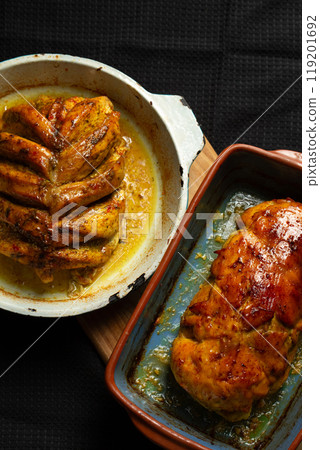 Baked meat dishes, chicken breast and stuffed meatloaf in a baking dish Baked meat dishes, chicken breast and stuffed meatloaf in a baking dish 119201692