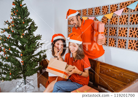 Joyful Friends Happily Celebrating Christmas Together with Gifts and Festive Cheer 119201700