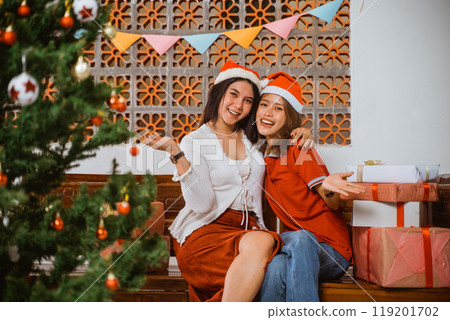 A Joyful and Merry Christmas Celebration with Friends and Colorful Festive Decorations A Joyful and Merry Christmas Celebration with Friends and Colorful Festive Decorations 119201702
