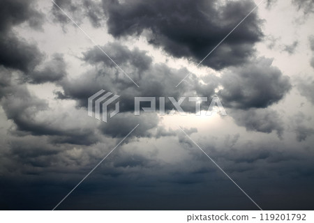 Dramatic gray sky with black clouds hiding the sun 119201792
