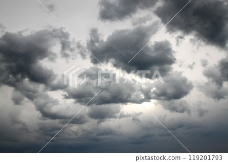 Dramatic gray sky with clouds hiding the sun 119201793