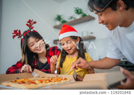 asian little family having christmas dinner together asian little family having christmas dinner together 119201848