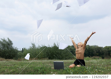 Happy woman throwing documents in the air Happy woman throwing documents in the air 119202037