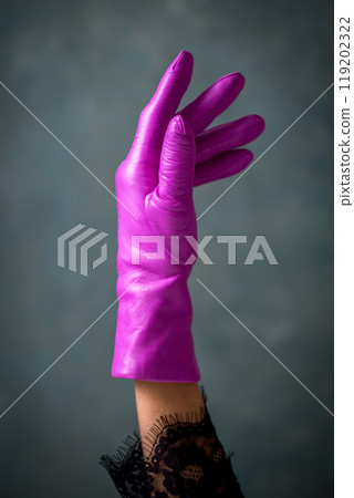 Bright fuchsia leather women's glove on a gray background, close-up 119202322