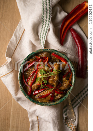 Stew with chicken, hot pepper and microgreens pea sprouts, photo in a rustic style Stew with chicken, hot pepper and microgreens pea sprouts, photo in a rustic style 119202481