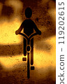 Bicycle sign on a road illuminated by streetlights 119202615