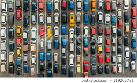 An aerial view of a crowded parking lot with cars neatly lined up, demonstrating patterns and organization in public parking areas An aerial view of a crowded parking lot with cars neatly lined up, demonstrating patterns and organization in public parking areas 119202781