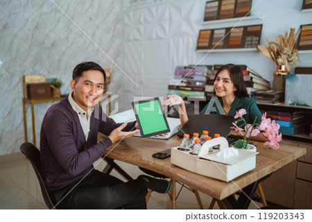 interior shop owner showing the digital tablet with green screen 119203343