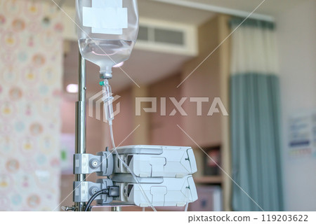 Close up medical intravenous IV drip in hospital background 119203622