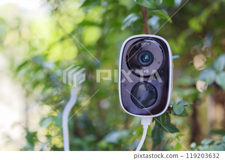 Security IP CCTV camera using solar energy install on the tree for home security system 119203632