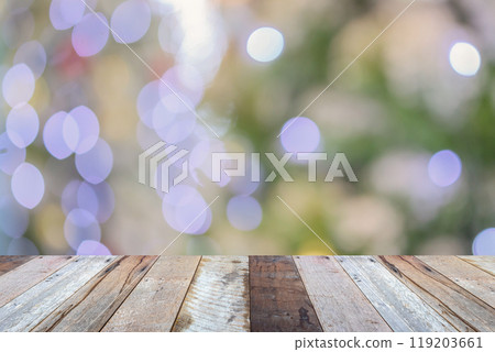 Empty wood table top with blur Christmas tree with bokeh light background Empty wood table top with blur Christmas tree with bokeh light background 119203661
