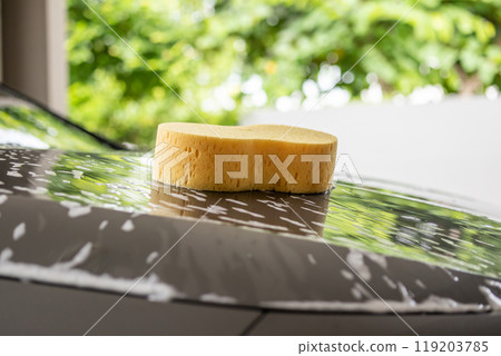 car cleaning and washing with yellow sponge and foam soap 119203785