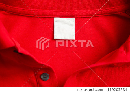 Blank white laundry care clothes label on red shirt fabric texture background Blank white laundry care clothes label on red shirt fabric texture background 119203884