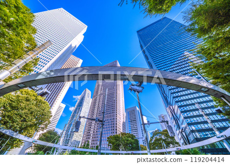 Shinjuku, Tokyo cityscape in Japan. View of Nishi-Shinjuku sign at the intersection behind Shinjuku Police Station and skyscrapers, October 7th Shinjuku, Tokyo cityscape in Japan. View of Nishi-Shinjuku sign at the intersection behind Shinjuku Police Station and skyscrapers, October 7th 119204414