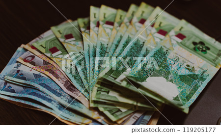 Currencies and money exchange trading concepts. Qatari 500 Riyals Bank Note . Qatari Currency roll 119205177