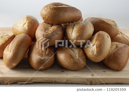 pile of fresh buns on display at bakery 119205309