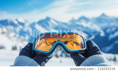 Hands holding goggles on a snowy mountain Hands holding goggles on a snowy mountain 119205319