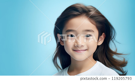 Portrait of a cute handsome happy Asian boy child with long hair and perfect skin, light blue background, banner. 119205793