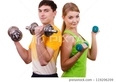 Couple exercising with dumbbells lifting weights Couple exercising with dumbbells lifting weights 119206209