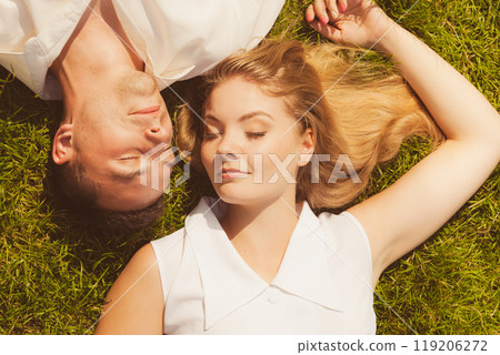 Man and woman lying on grass having date 119206272