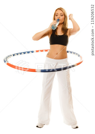 sporty fit girl doing exercise with hula hoop. 119206532