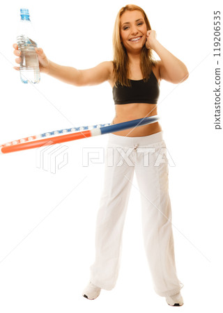 sporty fit girl doing exercise with hula hoop. 119206535