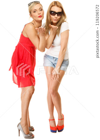 Two young women blowing kisses to the camera 119206572