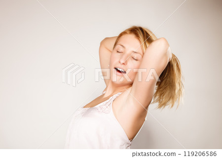 woman no makeup yawning and stretching woman no makeup yawning and stretching 119206586