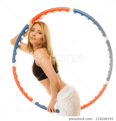 sporty fit girl doing exercise with hula hoop. 119206595