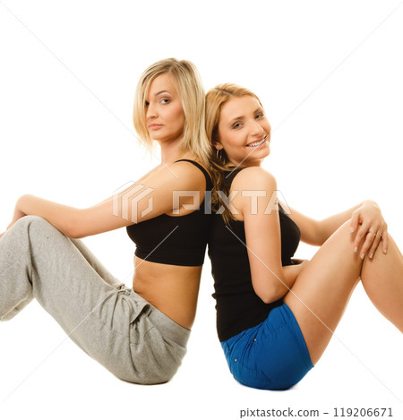 two young sporty women after intense workout 119206671