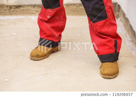 Person wearing red worker trousers 119206857