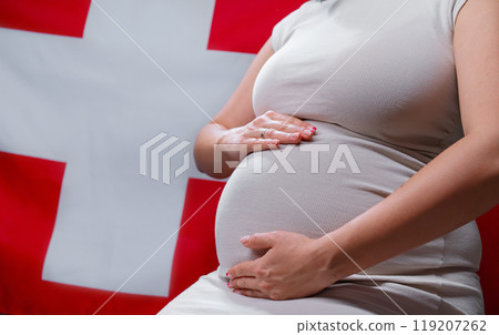 Unrecognizable Future Mother Expecting Baby On Swiss National Flag Background Unrecognizable Future Mother Expecting Baby On Swiss National Flag Background 119207262