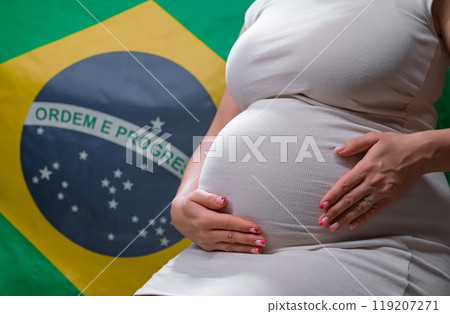 Unrecognizable Future Mother Expecting Baby, Brazilian National Flag Background 119207271