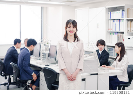 Smiling young female employee in the office 119208121