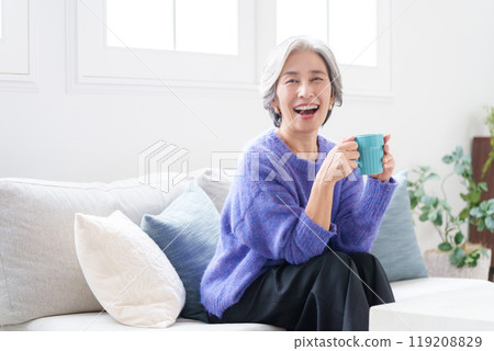 Senior woman relaxing with a mug Senior woman relaxing with a mug 119208829