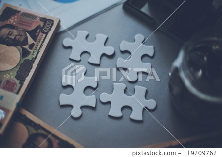 Four puzzle pieces and money Four puzzle pieces and money 119209762