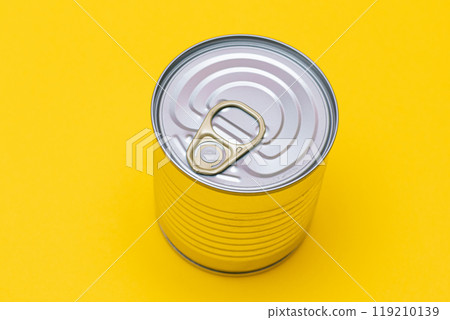 Unopened Tin Can with Blank Edge on Yellow Background Unopened Tin Can with Blank Edge on Yellow Background 119210139