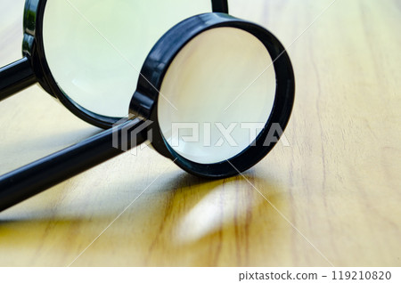 Close up of two magnifying glasses with customizable space for text or ideas 119210820