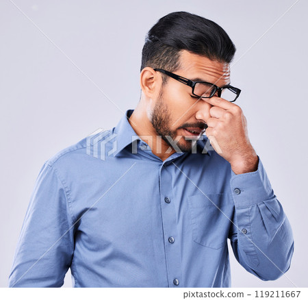 Tired, crisis and man with a headache on a studio background for mental health or burnout. Anxiety, sick or an Asian businessman with migraine pain from depression, mistake or frustrated with a fail 119211667