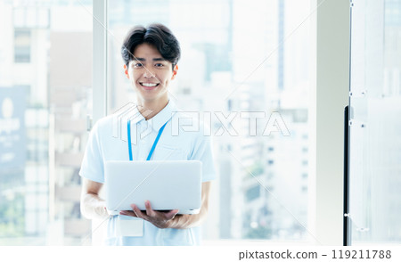 Care staff operating a computer 119211788