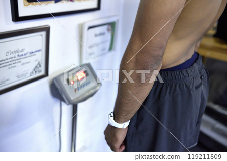 Scale, gym and man with goal weight for fitness, health and wellness for muscle development. Exercise, growth and athlete with body measurement for results, progress and checking self care target. Scale, gym and man with goal weight for fitness, health and wellness for muscle development. Exercise, growth and athlete with body measurement for results, progress and checking self care target. 119211809