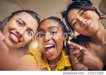 Friends, selfie and women happy, crazy and bond in a living room at home together on the weekend. Portrait, emoji and people with diversity pose for profile picture, blog or social media memory post Friends, selfie and women happy, crazy and bond in a living room at home together on the weekend. Portrait, emoji and people with diversity pose for profile picture, blog or social media memory post 119211889