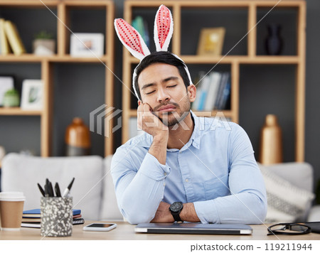 Tired, sleeping and a man for easter in an office with bunny ears for celebration or bored of a party. Stress, rabbit and a young Asian businessman with fatigue at a work desk with a problem 119211944