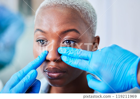 Doctor hands, woman and plastic surgery for cosmetics, aesthetic and facial transformation or nose job. Medical worker with rhinoplasty of african patient or client face, dermatology help or support Doctor hands, woman and plastic surgery for cosmetics, aesthetic and facial transformation or nose job. Medical worker with rhinoplasty of african patient or client face, dermatology help or support 119211969