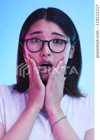 Surprise, shocked and face of Asian woman with wow expression or open mouth for drama, deal and promotion. Omg, wtf and portrait of person with discount emoji isolated in a studio blue background Surprise, shocked and face of Asian woman with wow expression or open mouth for drama, deal and promotion. Omg, wtf and portrait of person with discount emoji isolated in a studio blue background 119212217
