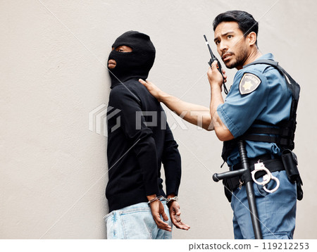 Man, police and walkie talkie with criminal for arrest, crime or justice in theft, robbery or violence. Male person, officer or security guard with handcuffs and force on suspect and calling backup 119212253