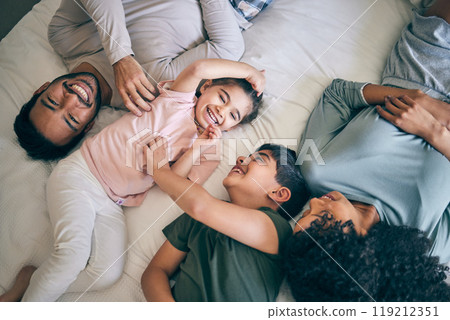 Happy family, bed and playing in bonding, weekend or day off in relax together above at home. Top view of father, mother and children smile in joy or laughing for fun parents or morning in bedroom 119212351